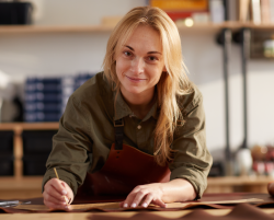femme cheffe de cuisine en tablier qui écrit